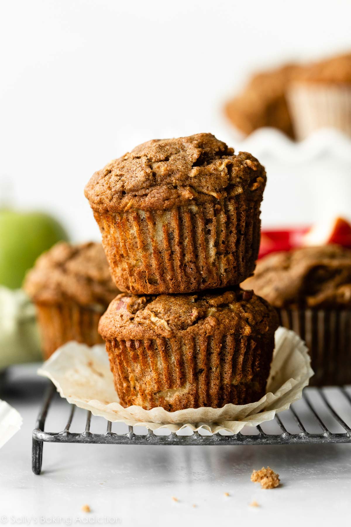 stack of two healthy apple muffins sitting on wire cooling rack.