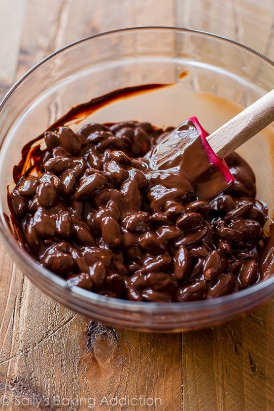 melted chocolate and almonds combined in a glass bowl