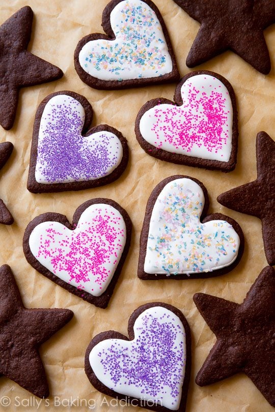 heart and star chocolate sugar cookies decorated with royal icing and sprinkles