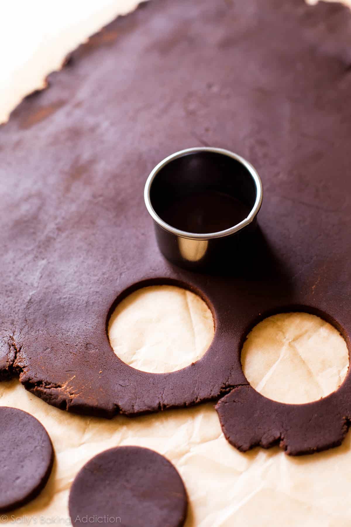 chocolate sugar cookie dough rolled out with a circle cookie cutter