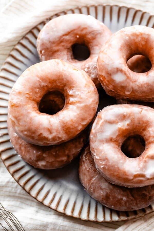 glazed doughnuts on gray plate.