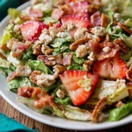 strawberry bacon salad on a white plate