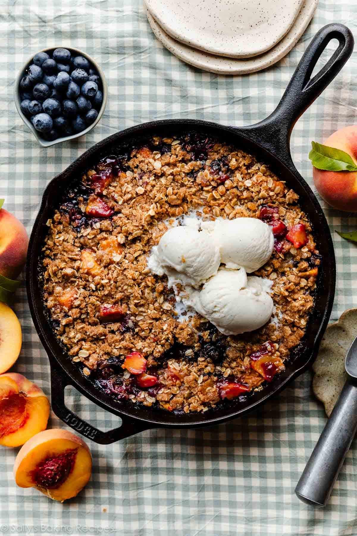 brown butter blueberry peach crisp in cast iron skillet.