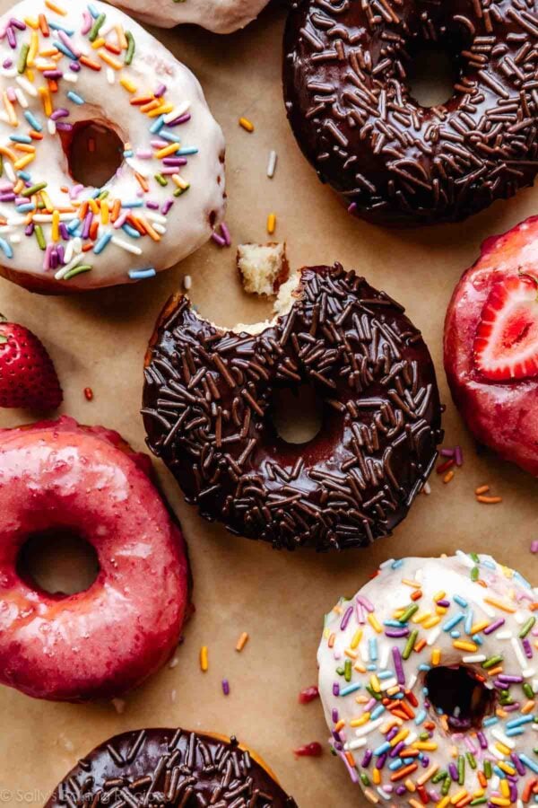 doughnut frostings on doughnuts including chocolate, strawberry, and vanilla-topped doughnuts.