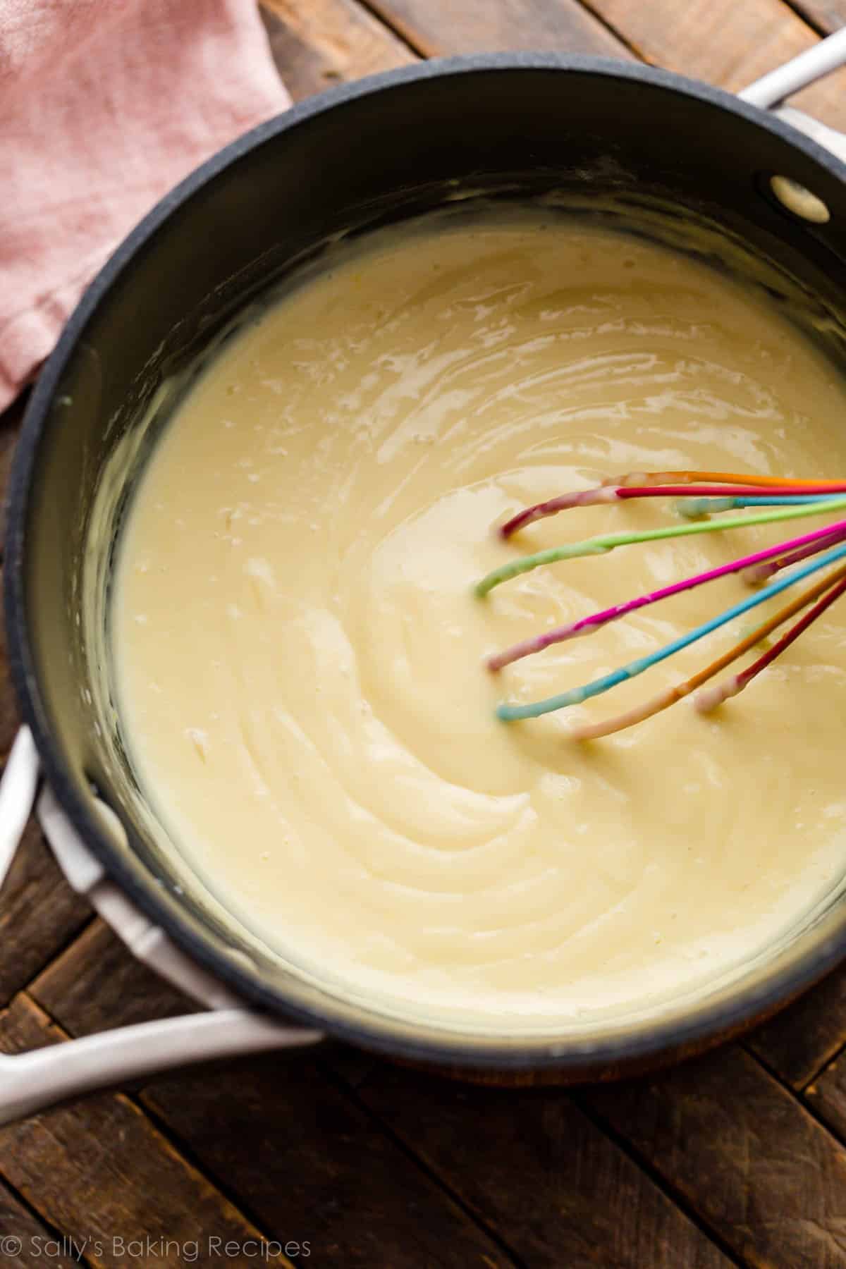 pudding in pot with rainbow whisk.