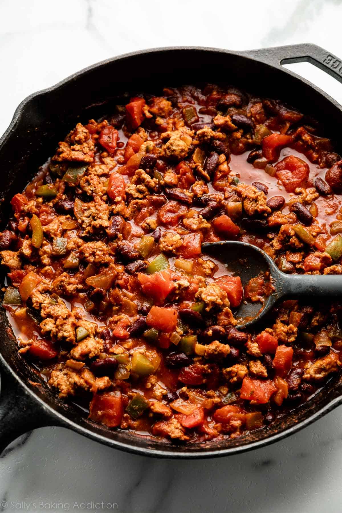 cooked chili mixture in cast iron skillet.