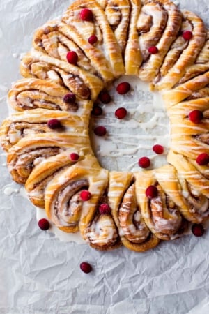 overhead image of cinnamon roll wreath with vanilla icing