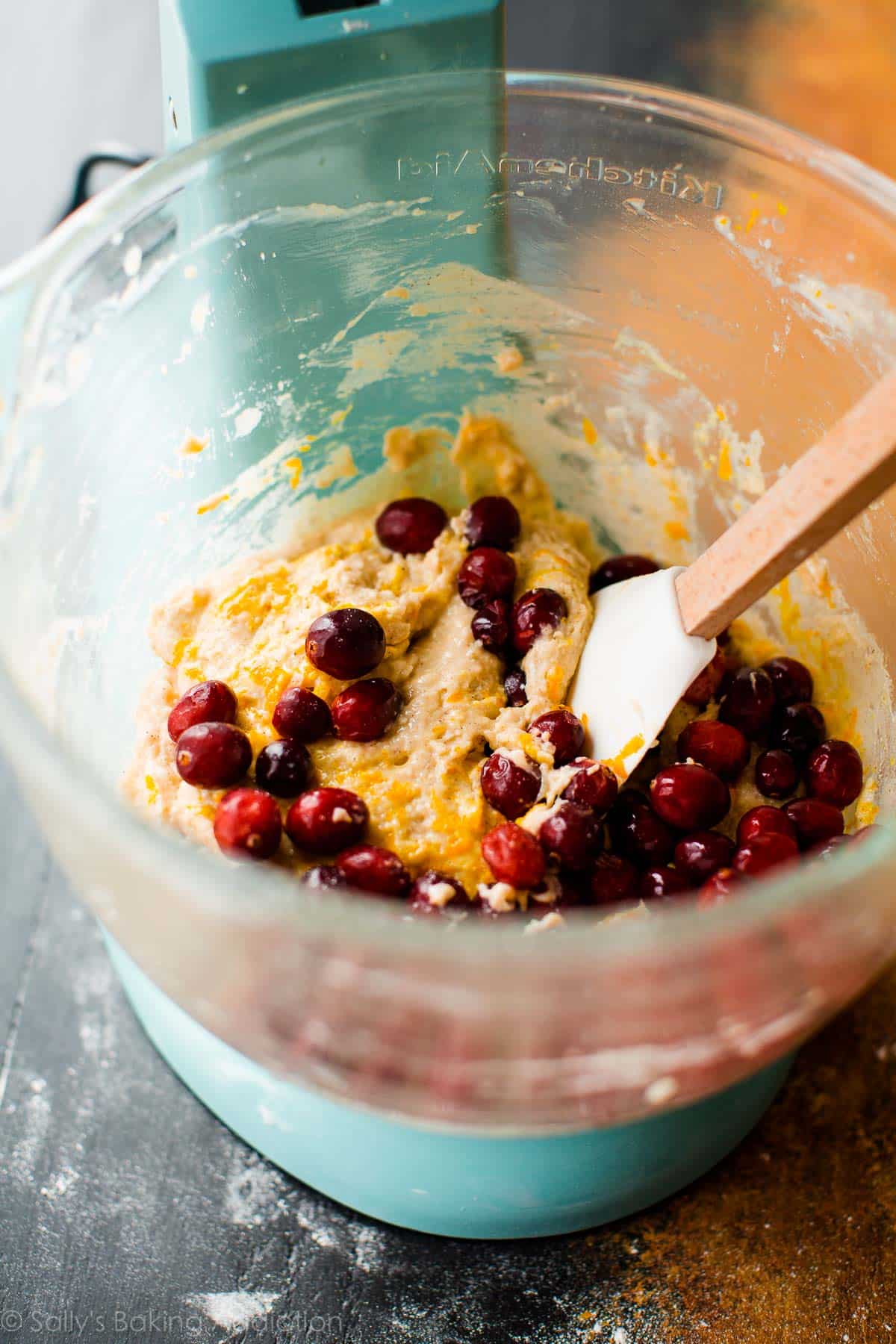 cranberry cardamom spice muffin batter in a glass stand mixer bowl