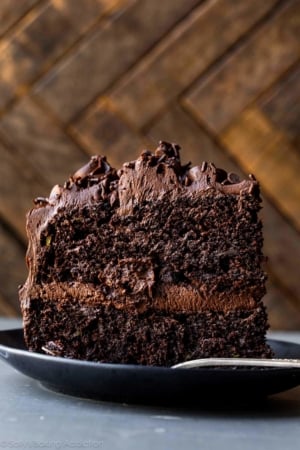 slice of chocolate zucchini cake on a black plate