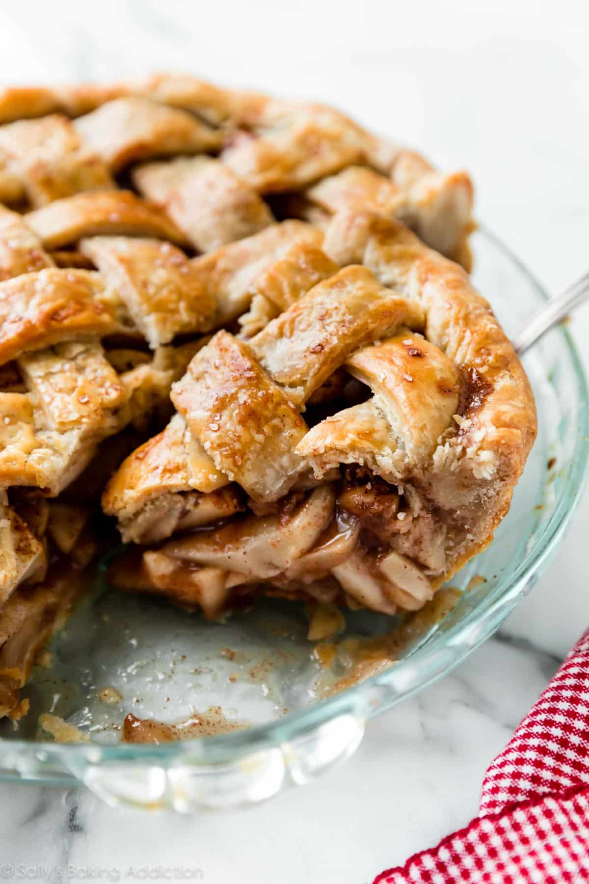 apple pie with a slice on pie server