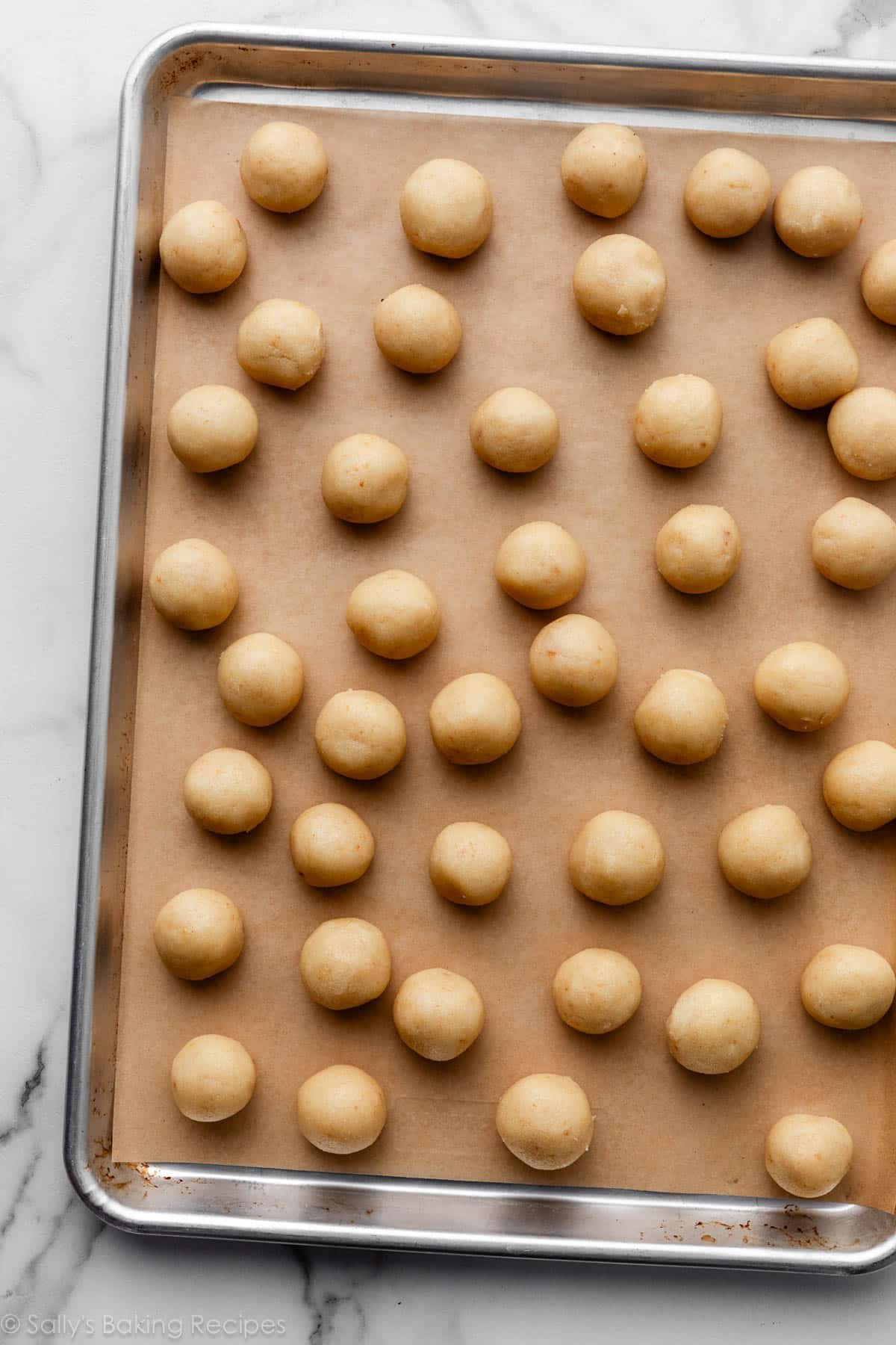 cake balls on lined baking sheet.