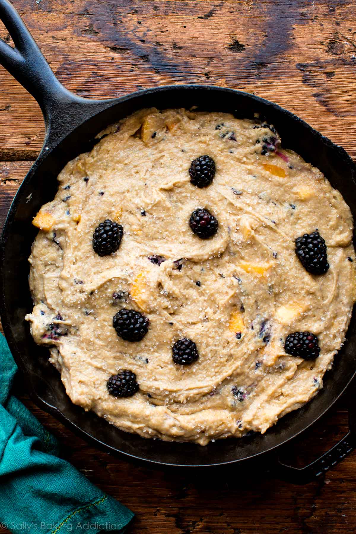 blackberry peach skillet cornmeal cake batter in a skillet before baking