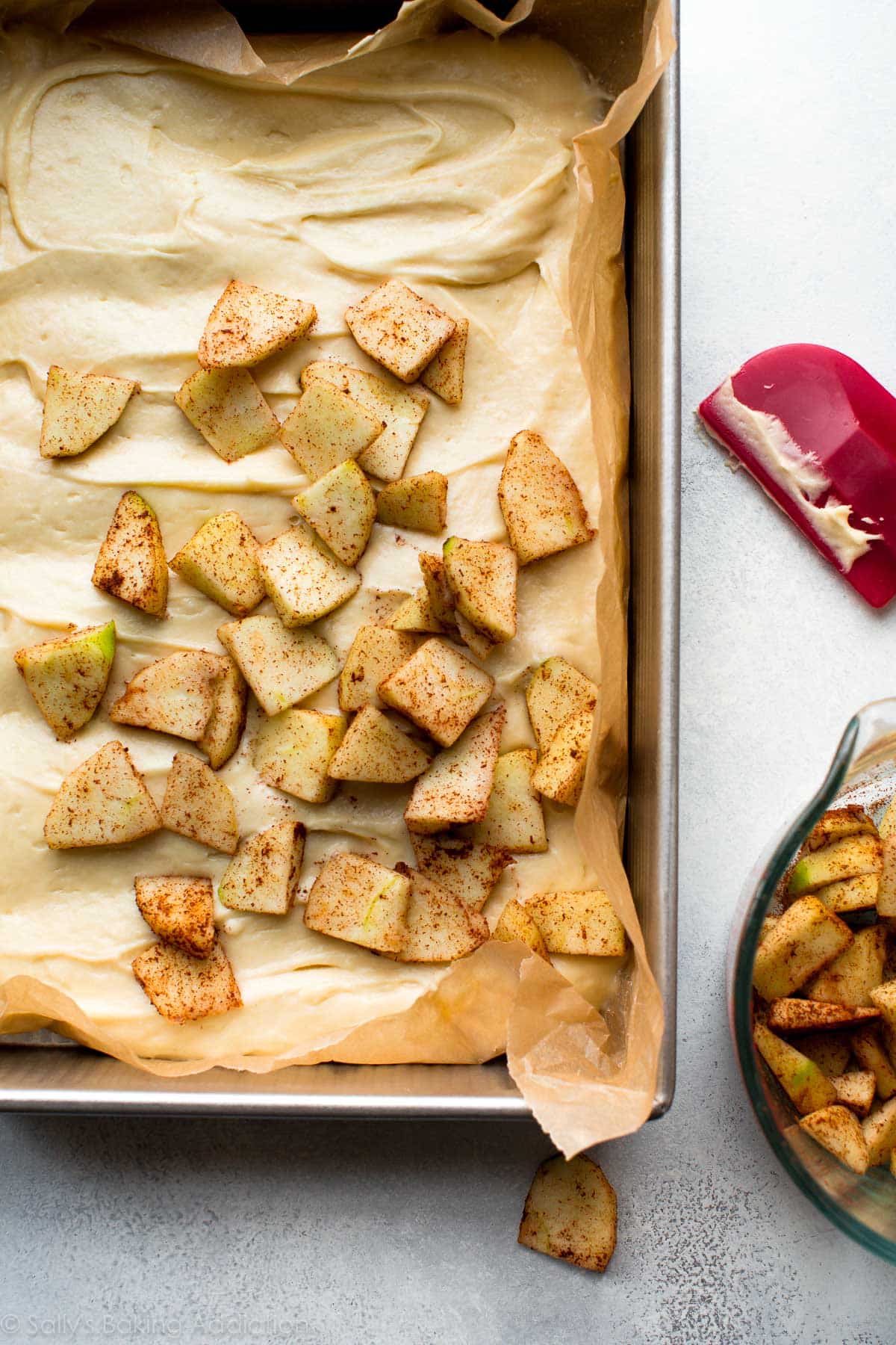 layer of chopped apples on top of cake batter in a 9x13 baking pan