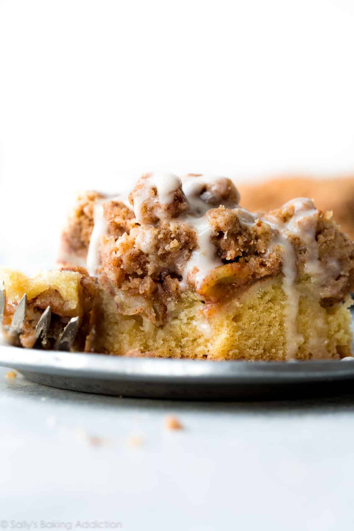 slice of apple crumb cake on a silver plate