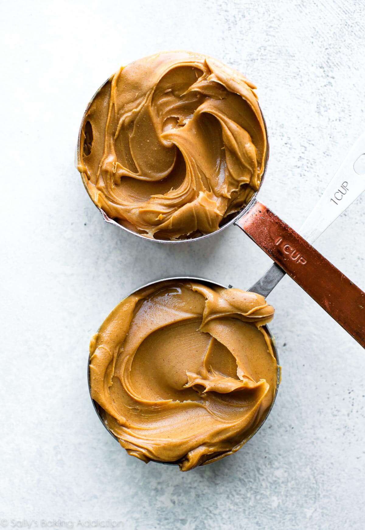 2 1 cup measuring cups filled with peanut butter