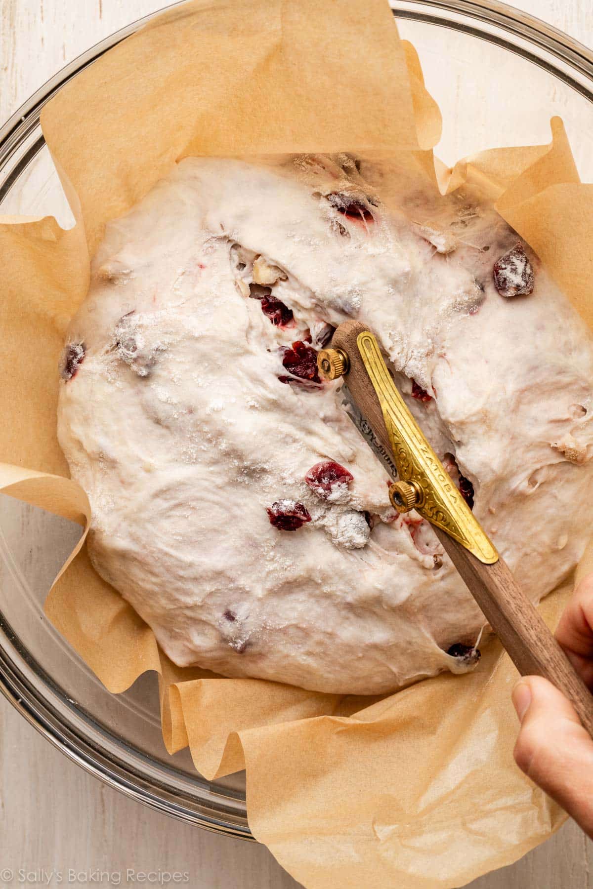 bread lame slicing into dough.