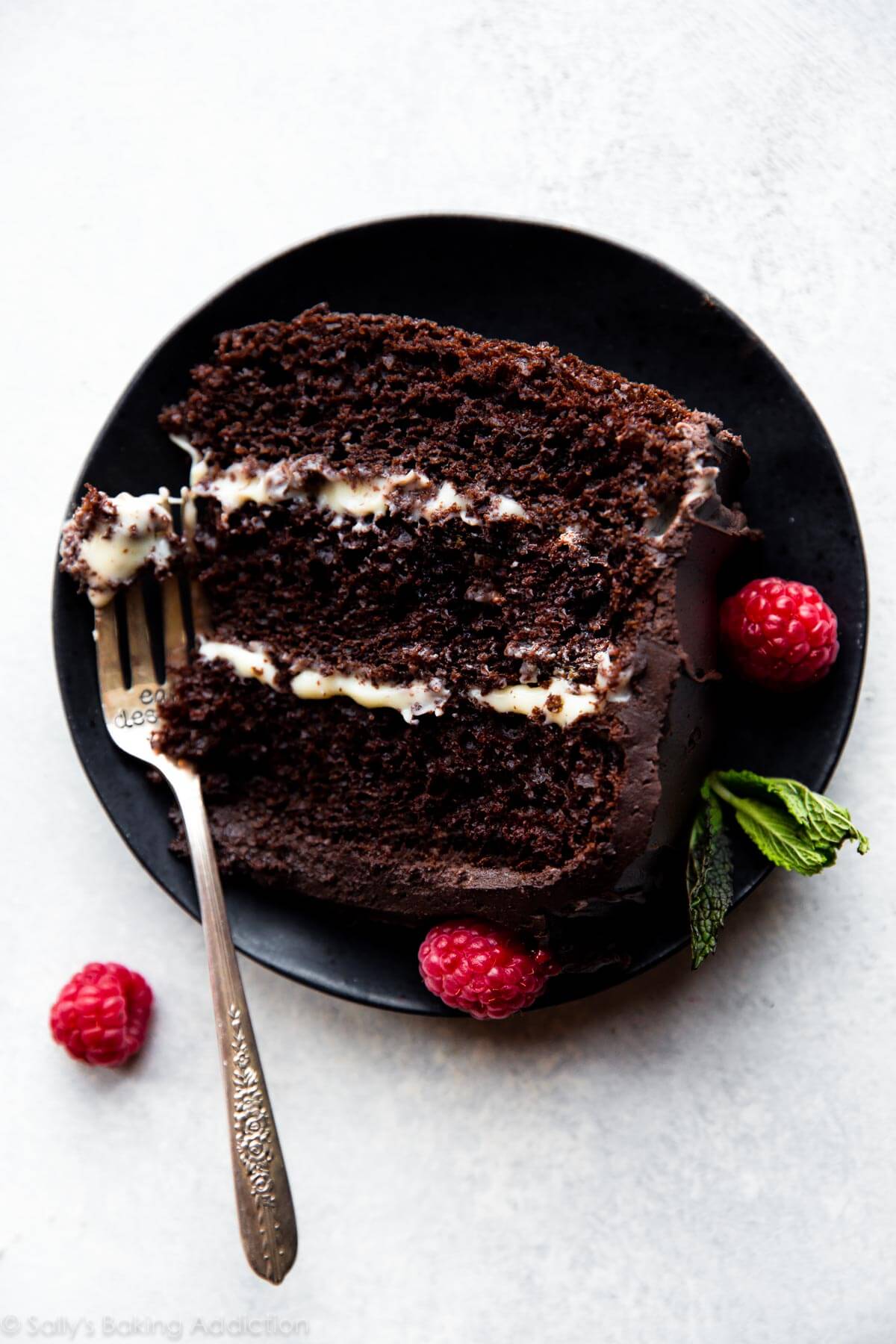 slice of tuxedo cake on a black plate with a fork