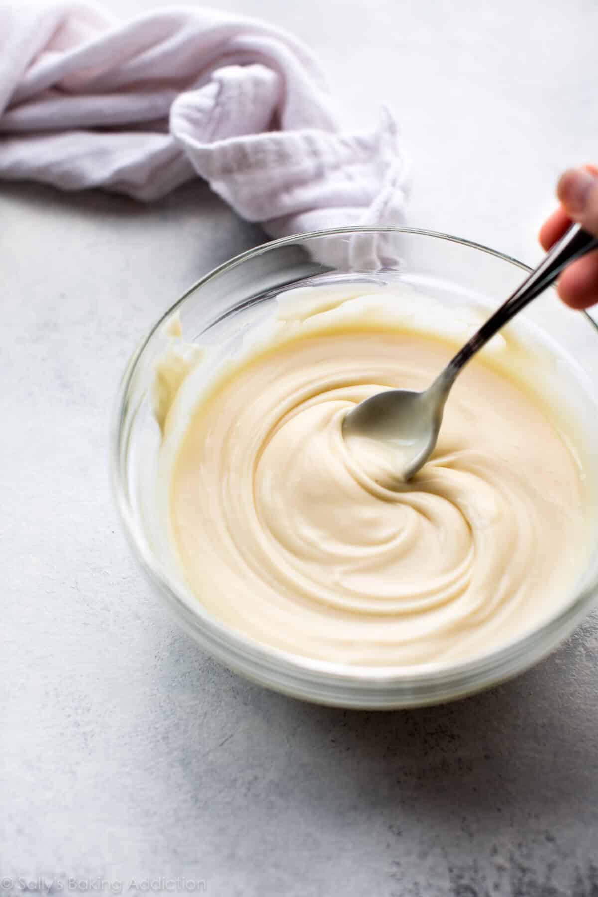 white chocolate ganache in a glass bowl