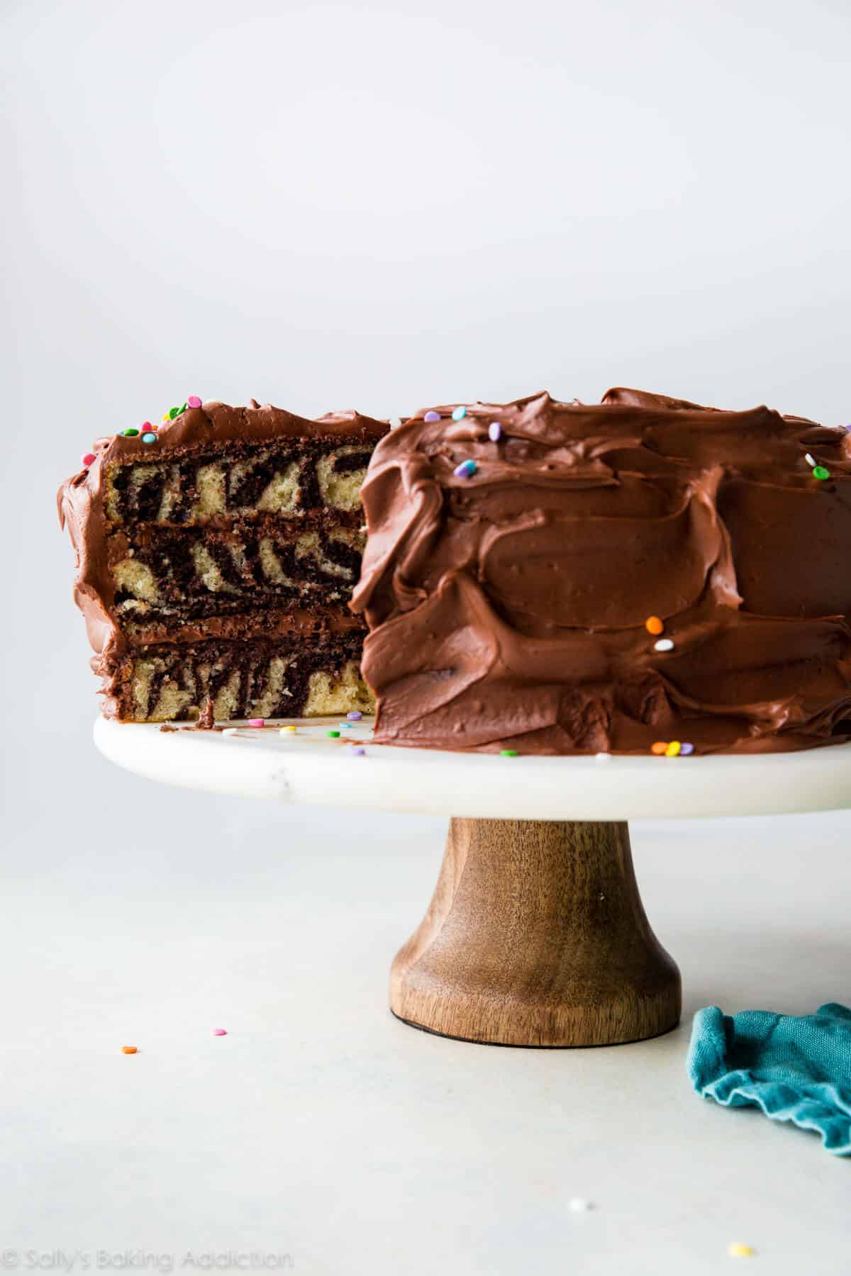 zebra cake on a wood and marble cake stand