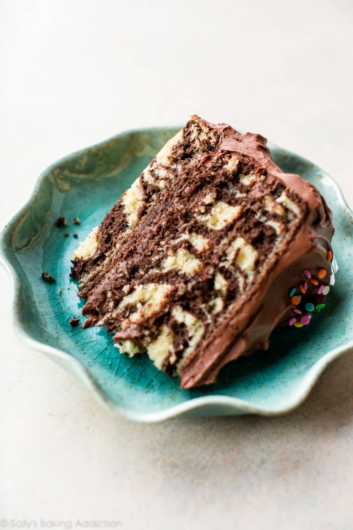 slice of zebra cake on a teal plate