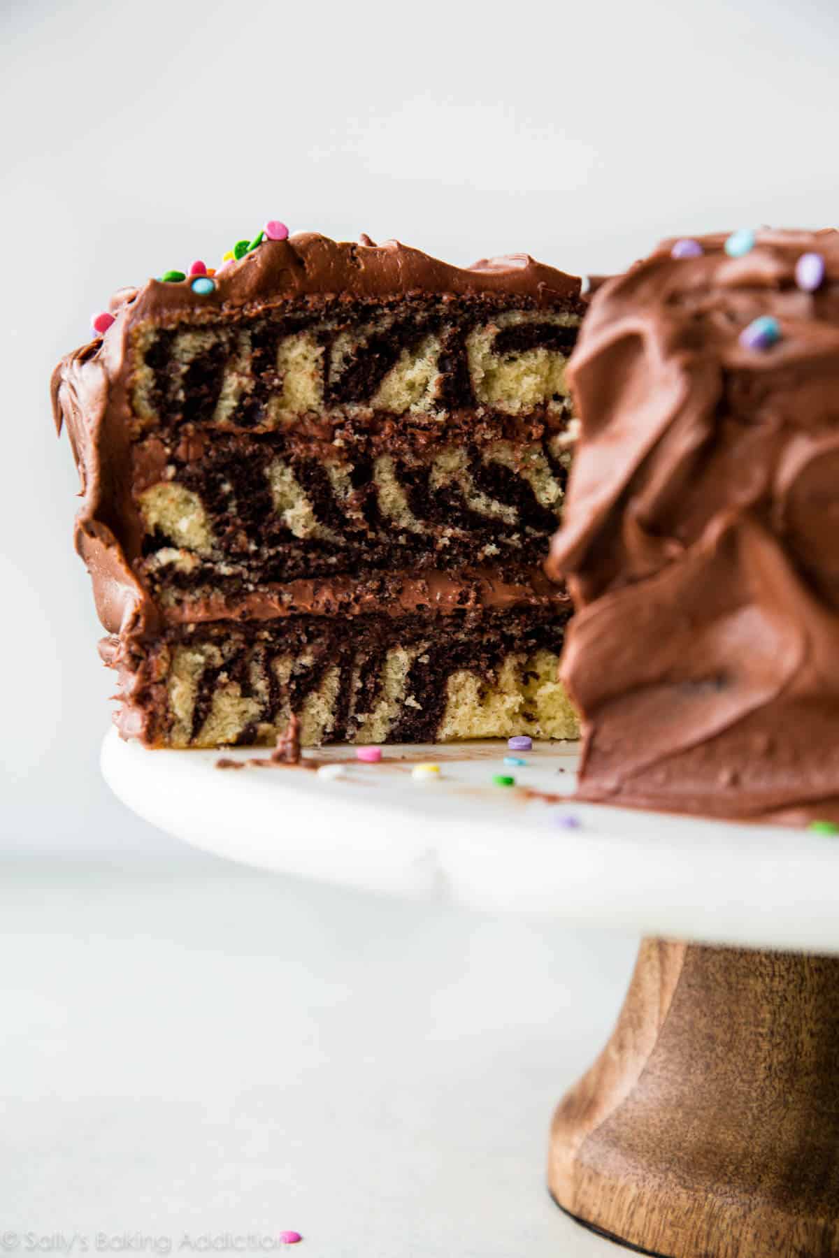 zebra cake on a wood and marble cake stand