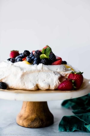 pavlova on a marble and wood cake stand