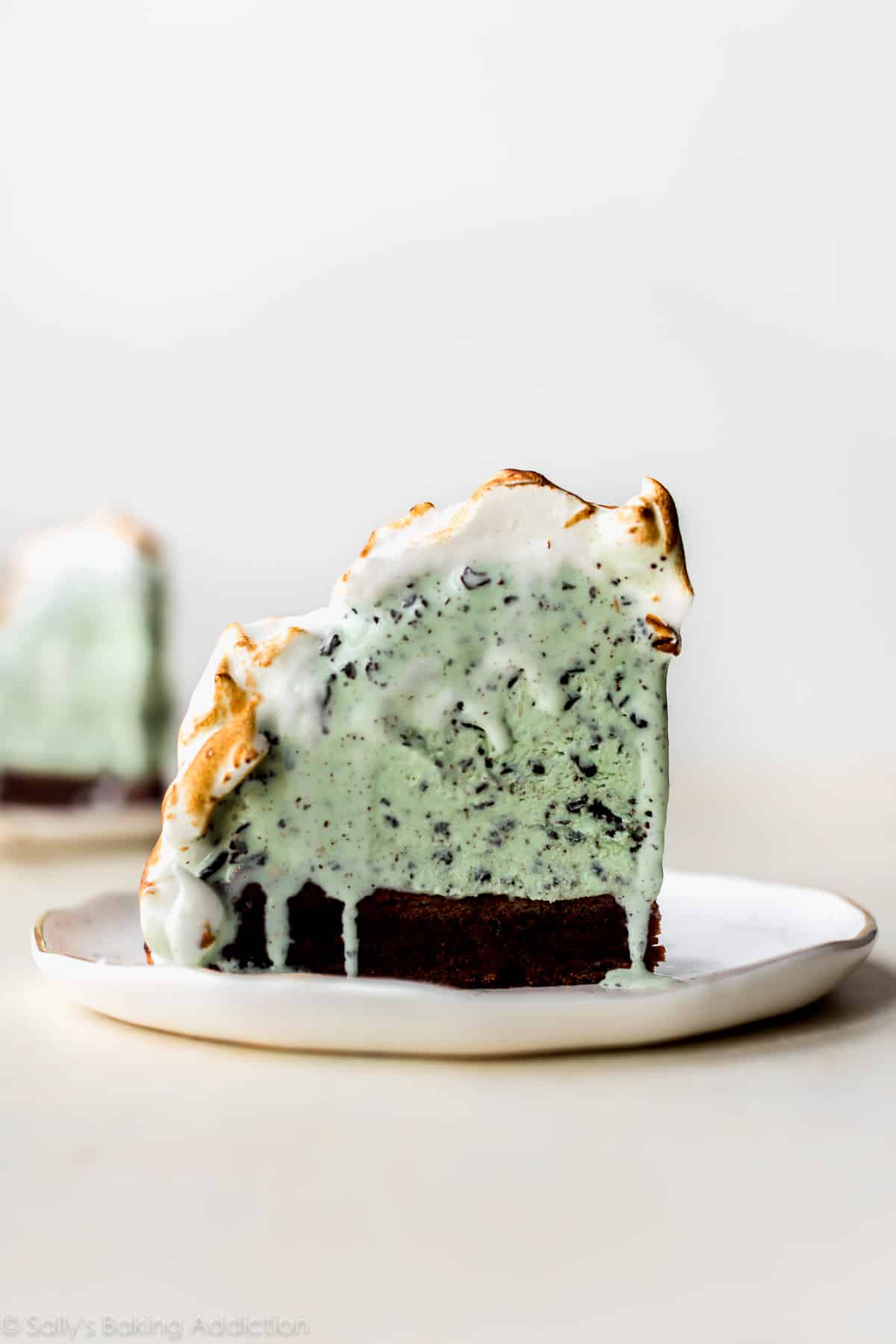 slice of brownie baked Alaska on a white plate