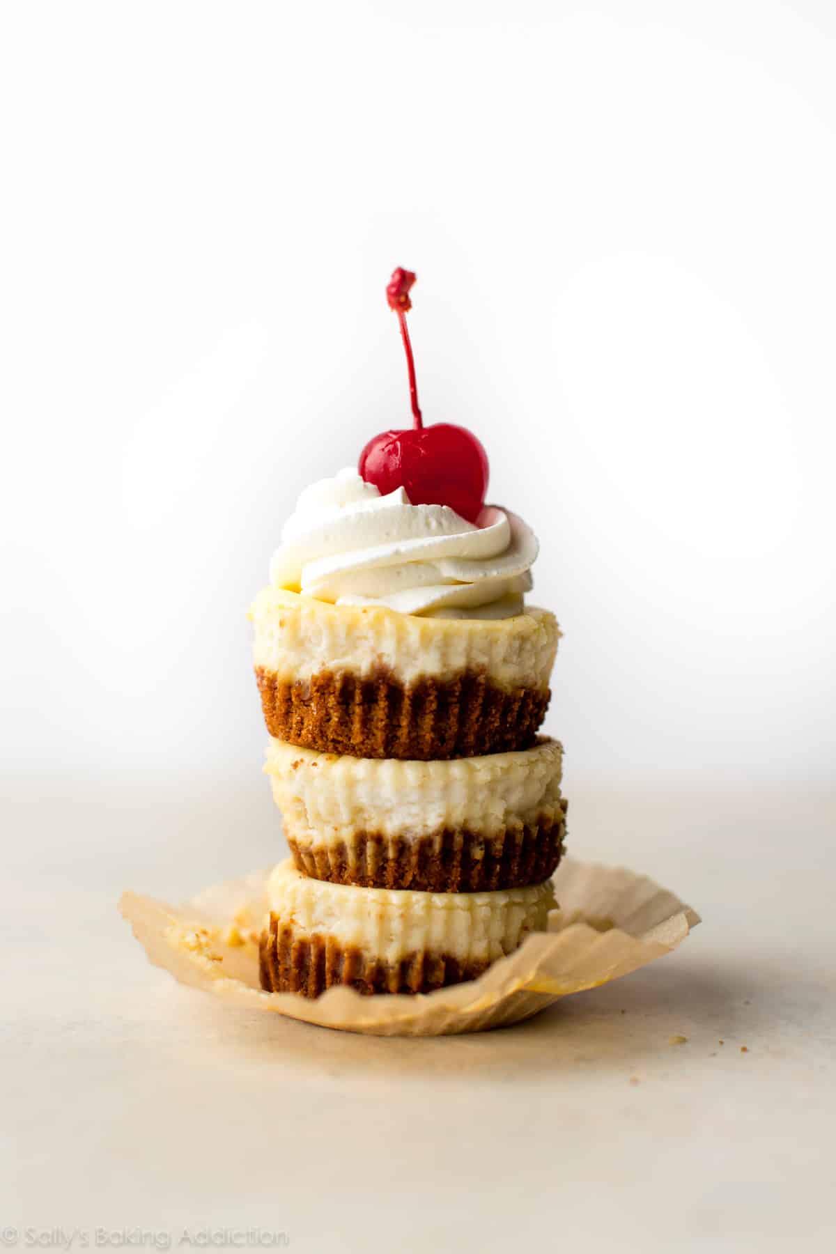 stack of mini cheesecakes with a cherry on top