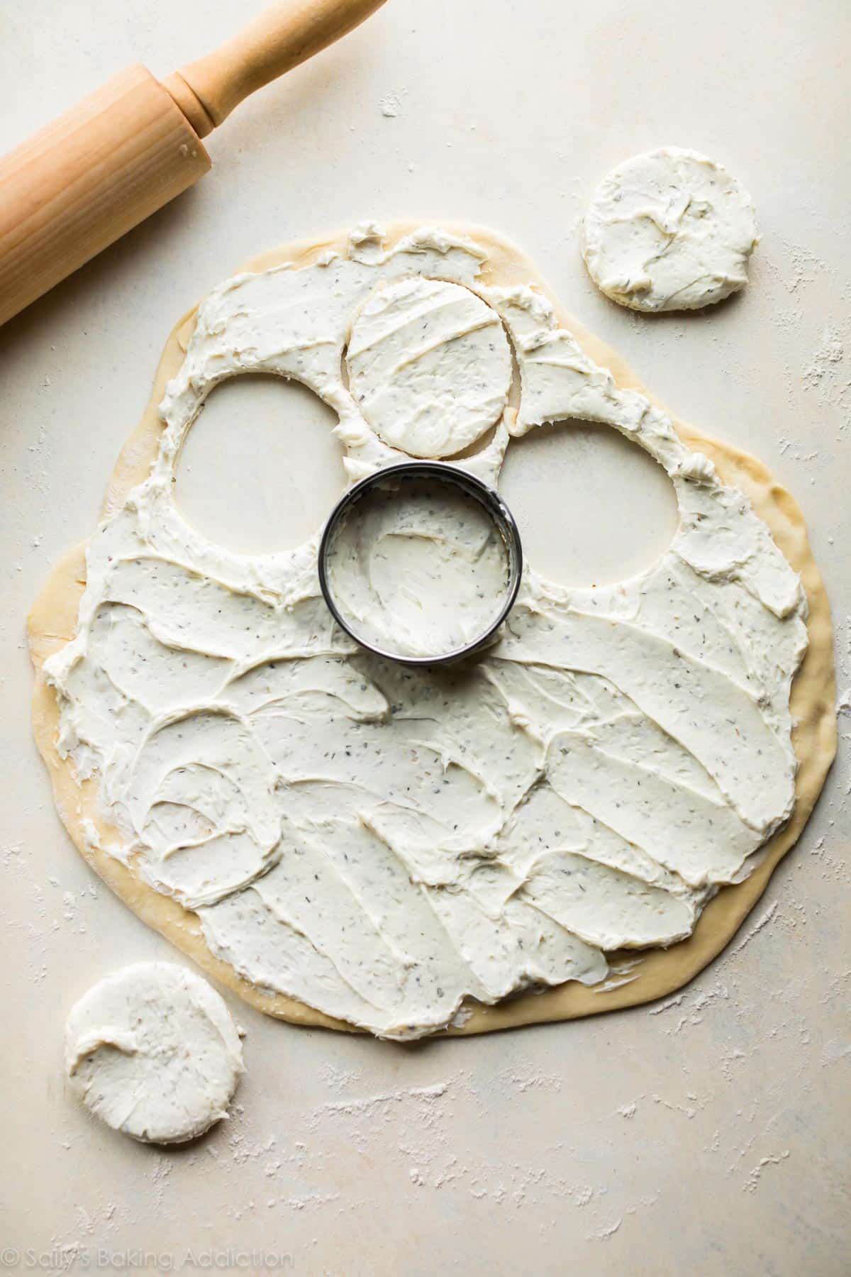 rolled out dough topped with cheese filling cut out into circles