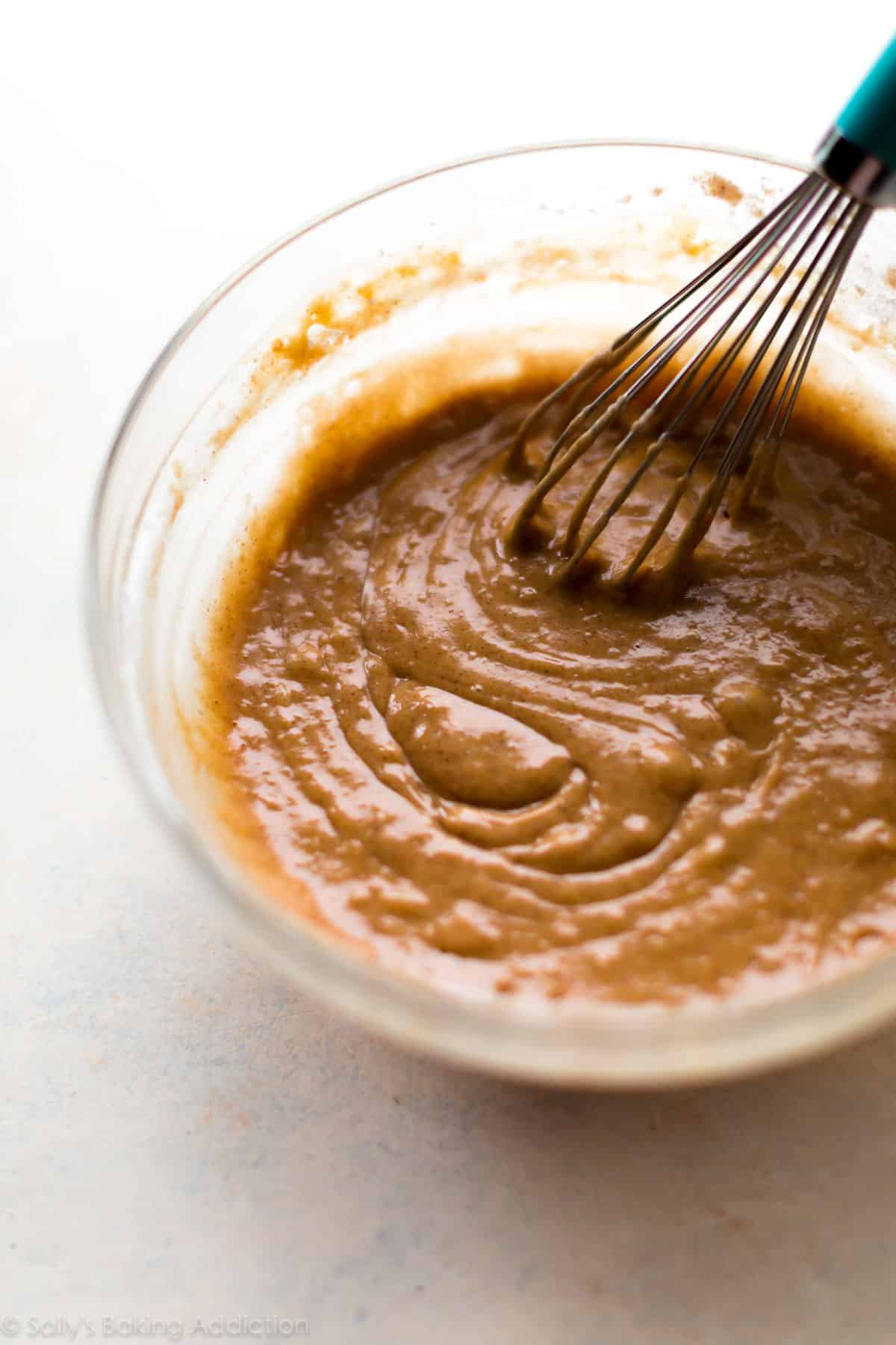 apple cider donut batter in a glass bowl