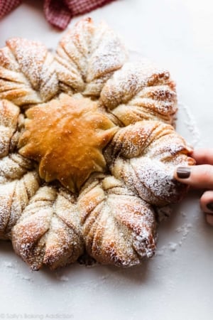 cinnamon sugar star bread with hand pulling apart a piece