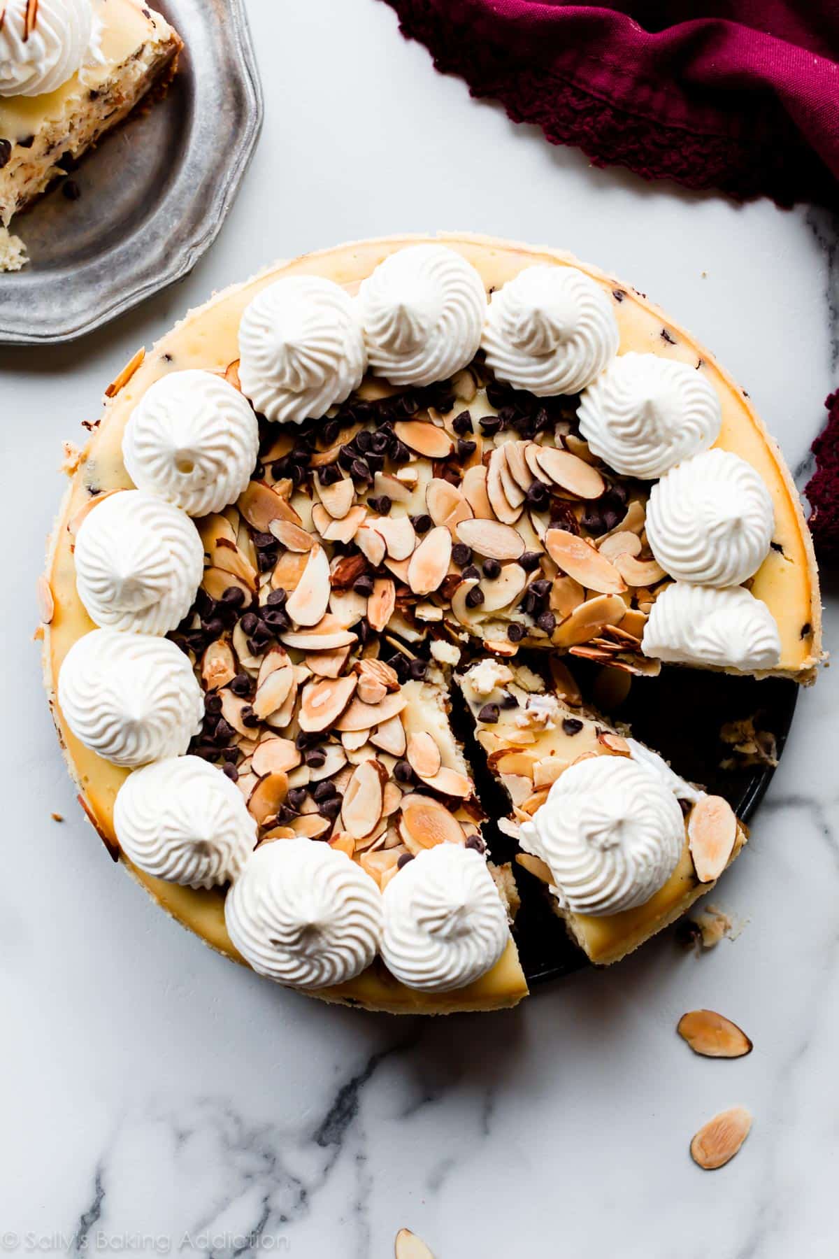 overhead image of amaretto chocolate chip cheesecake with homemade whipped cream