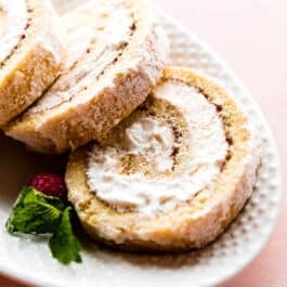 Champagne cake roll slices on a white serving platter