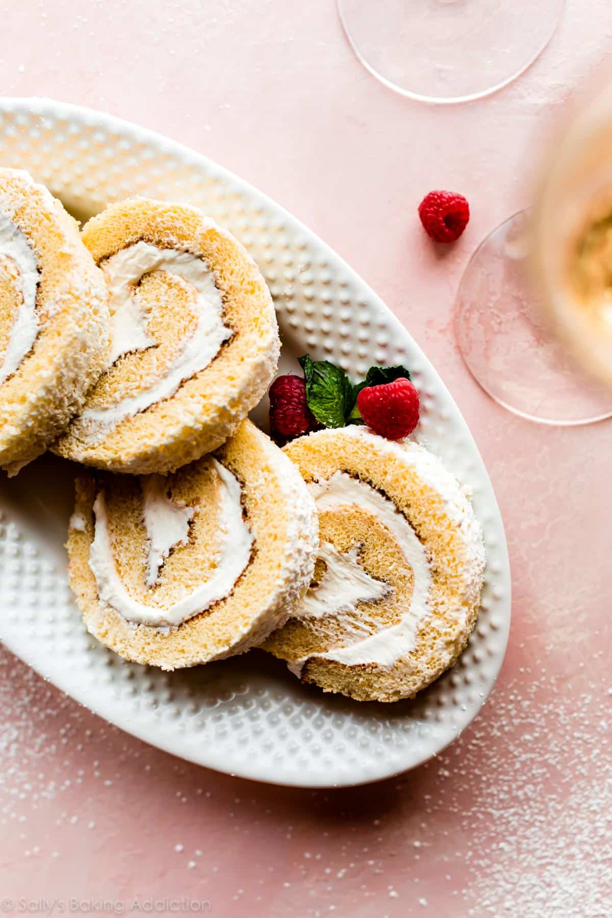 slices of champagne cake roll on a white serving platter