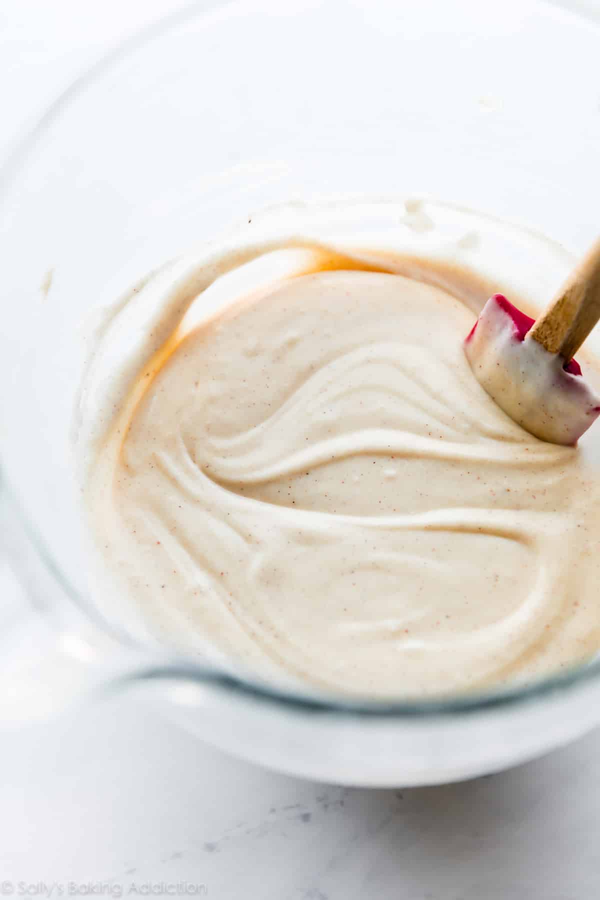 Almond cinnamon cupcake batter in a glass bowl