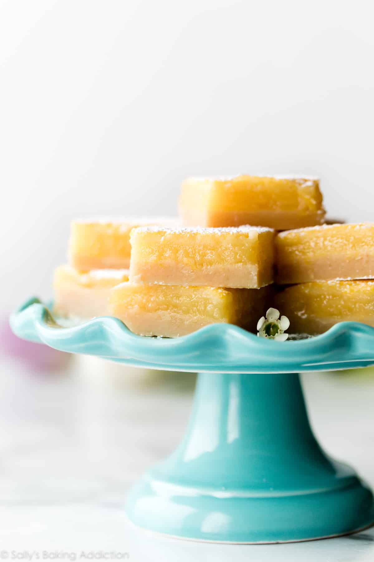 Lemon bars on teal cake stand