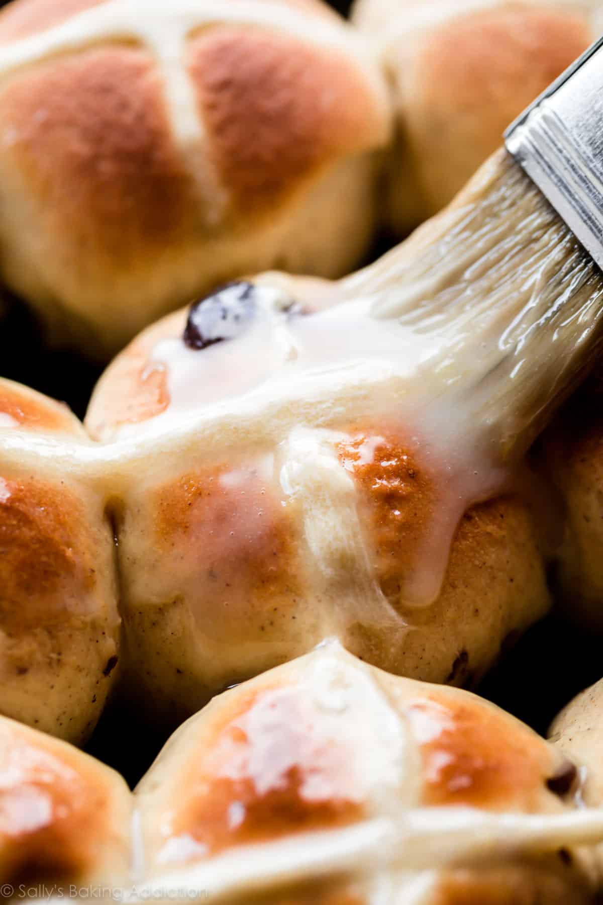 Golden brown hot cross buns with glaze on top