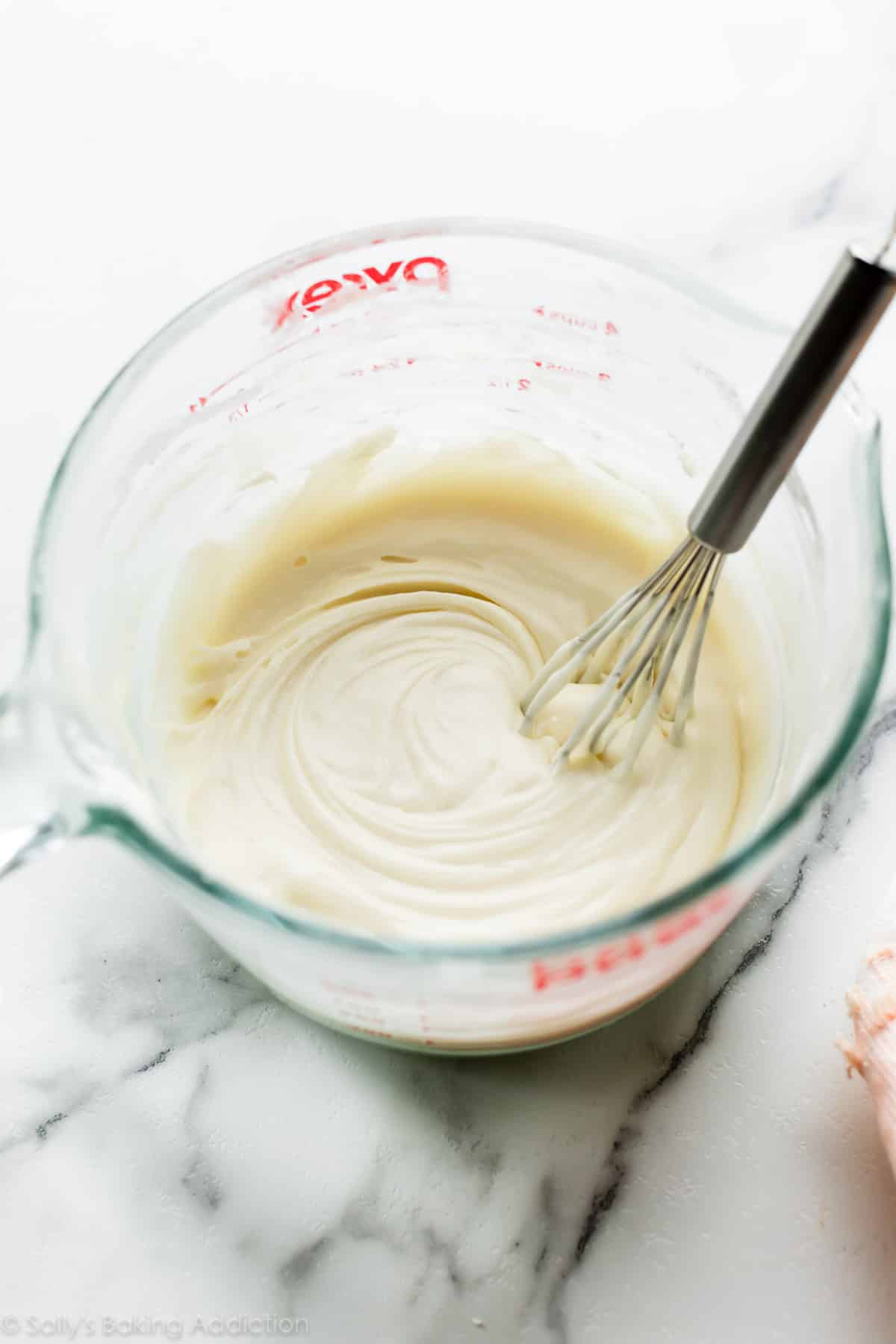 Melted white chocolate in glass bowl