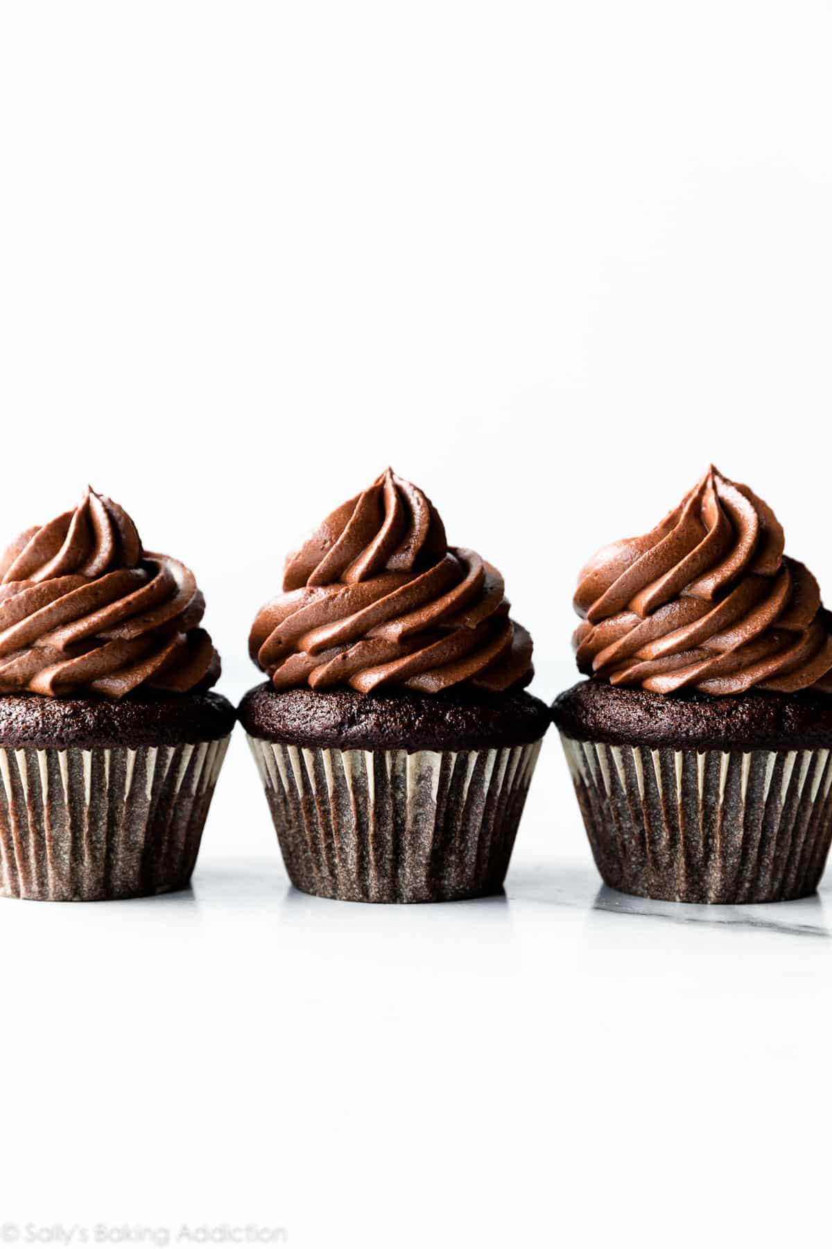 whipped chocolate ganache frosting on top of chocolate cupcakes