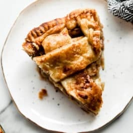 slice of apple cheddar pie on a white plate