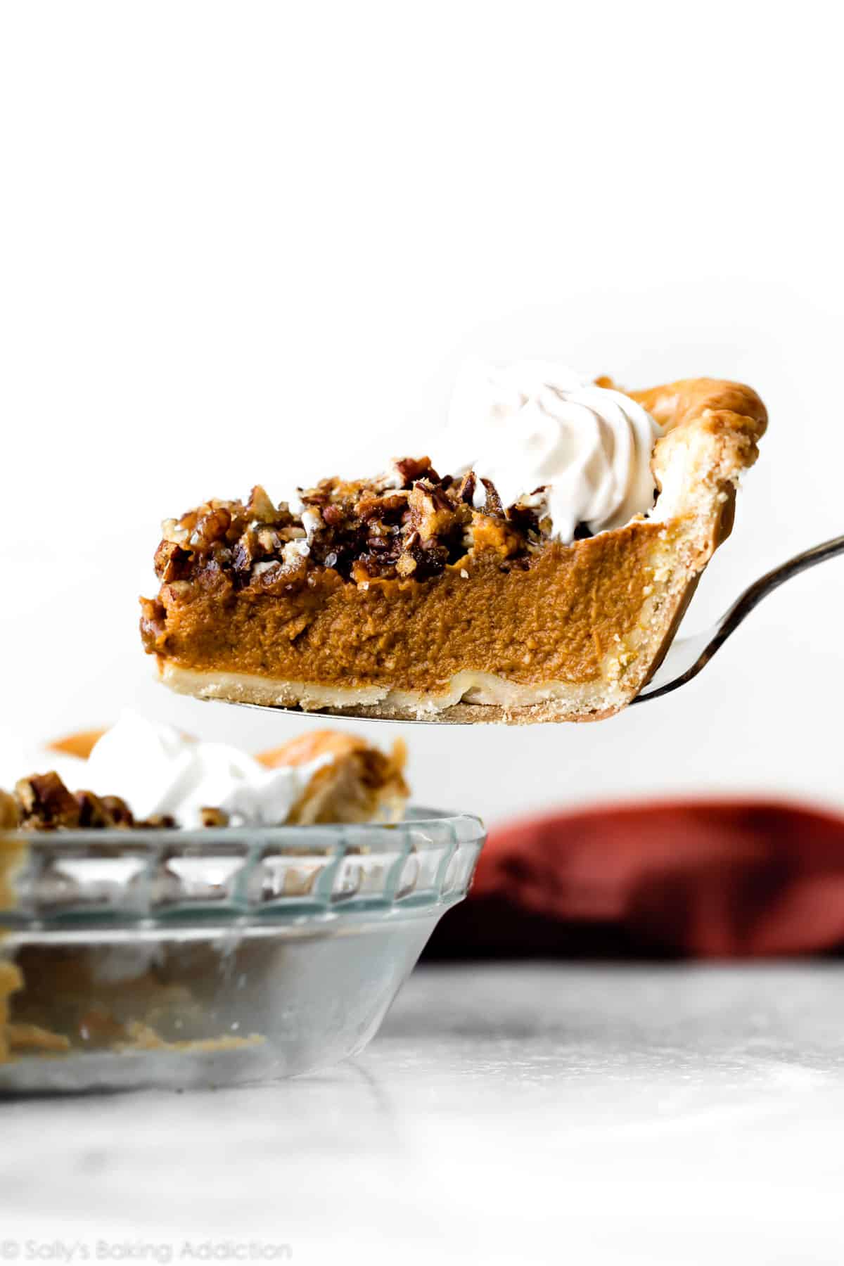 slice of pecan praline pumpkin pie on a pie server