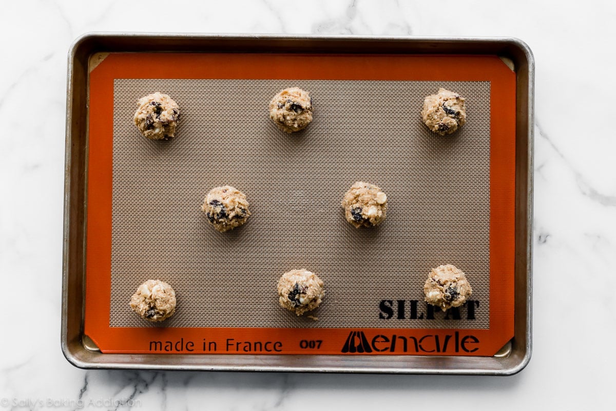 white chocolate cherry oatmeal cookie dough balls on baking sheet