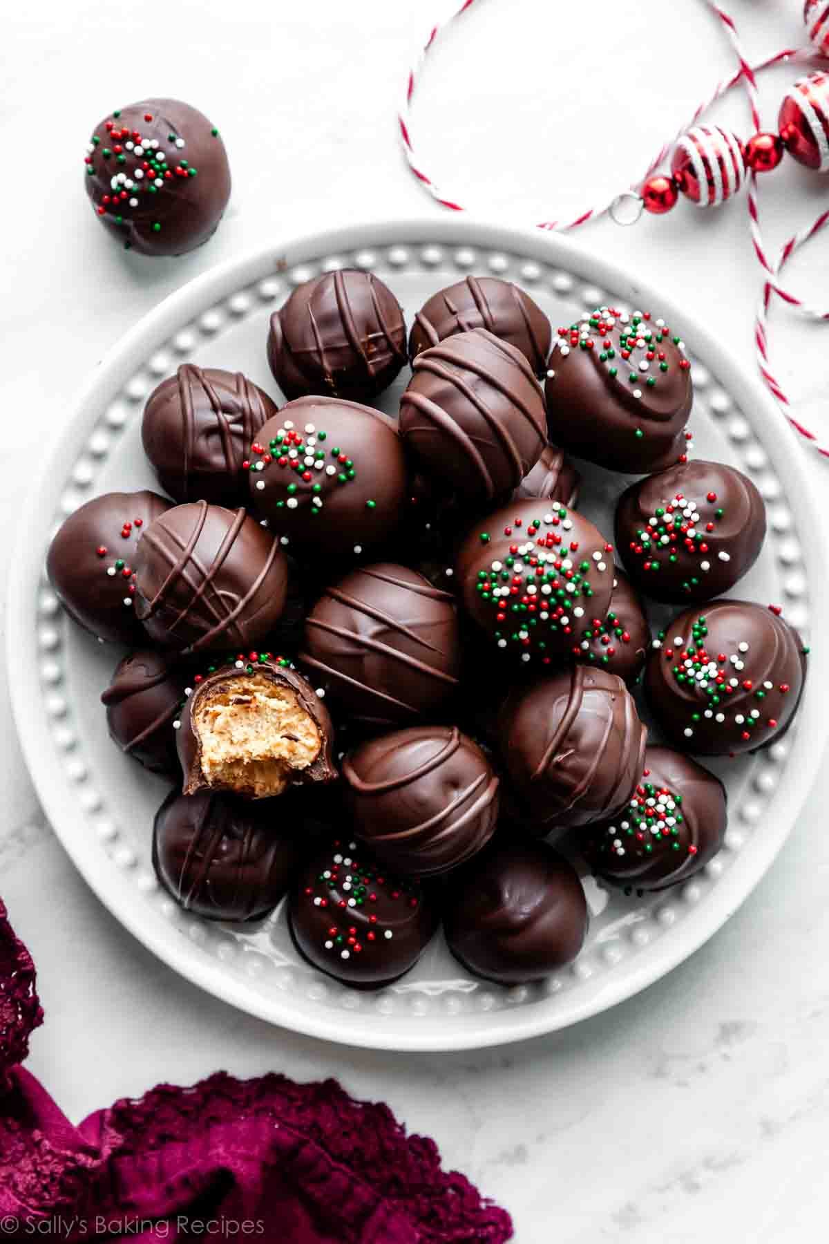 plate of peanut butter balls with one shown a bite taken out.