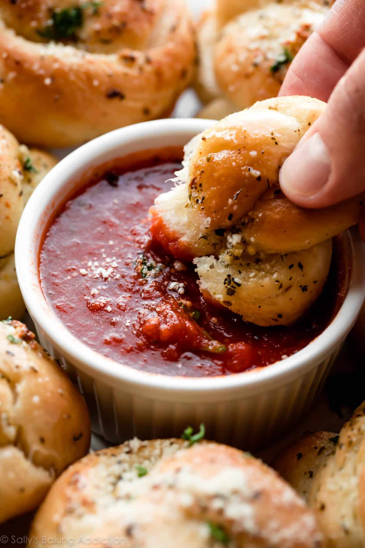 garlic knot dipped in marinara sauce