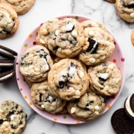 Oreo cookies and cream cookies on pink plate