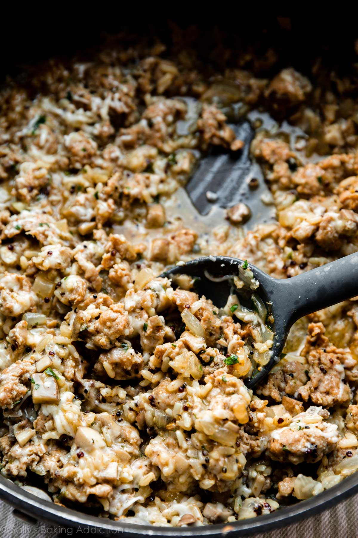 cooked sausage, rice, and cheese filling in skillet