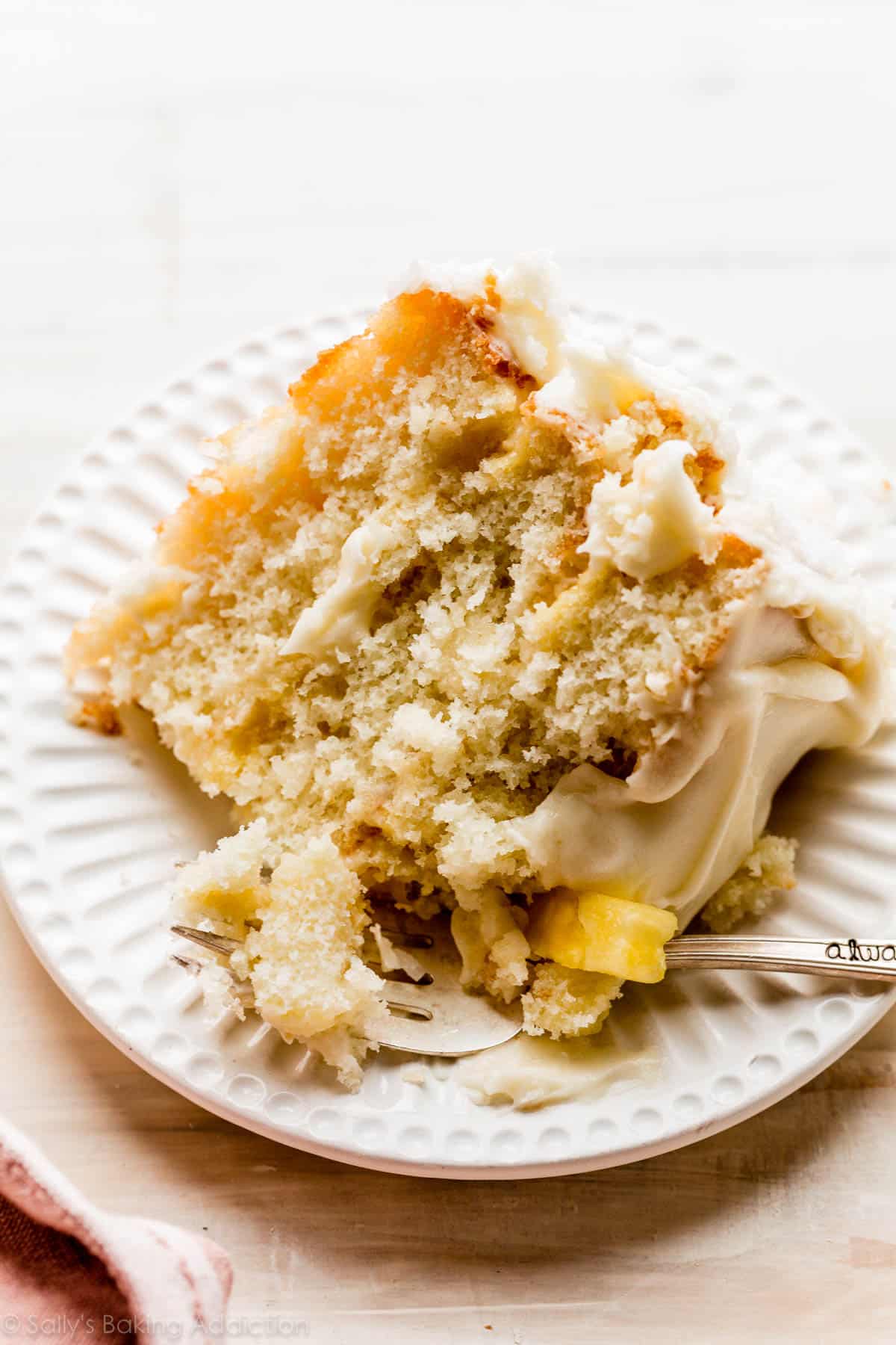 slice of pineapple coconut cake on white plate