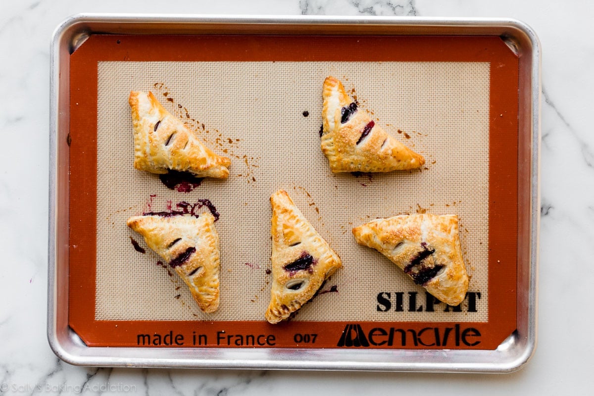 baked turnovers on baking sheet