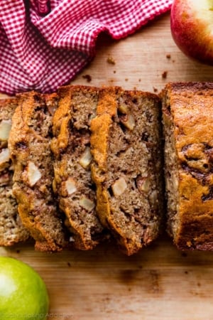 slices of apple cinnamon bread on wooden cutting board.