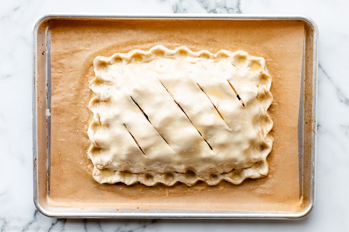 rectangle pie with top crust on a baking sheet and shown before baking